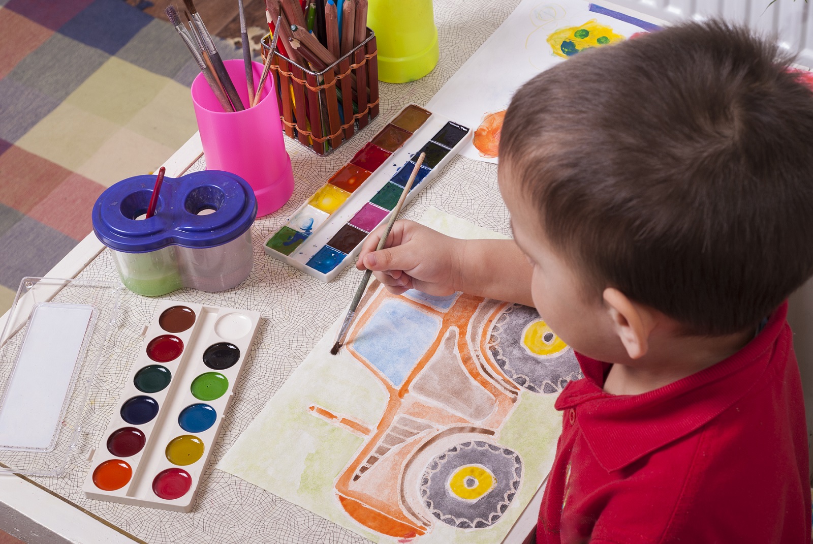 child painting a tractor to raise awareness for farm safety