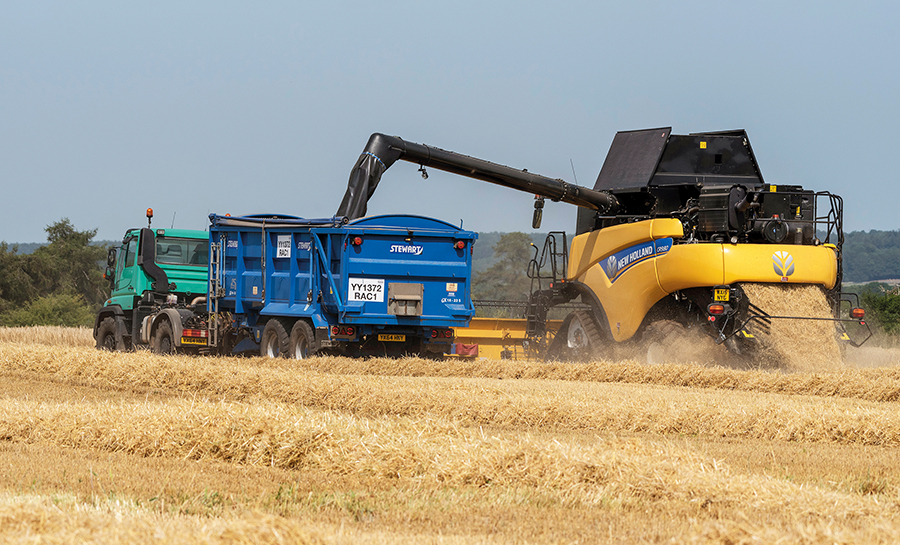 Combine harvester working on farm