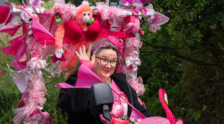 close up of a woman in pink with decorated pink tractor, at the pink ladies tractor road run