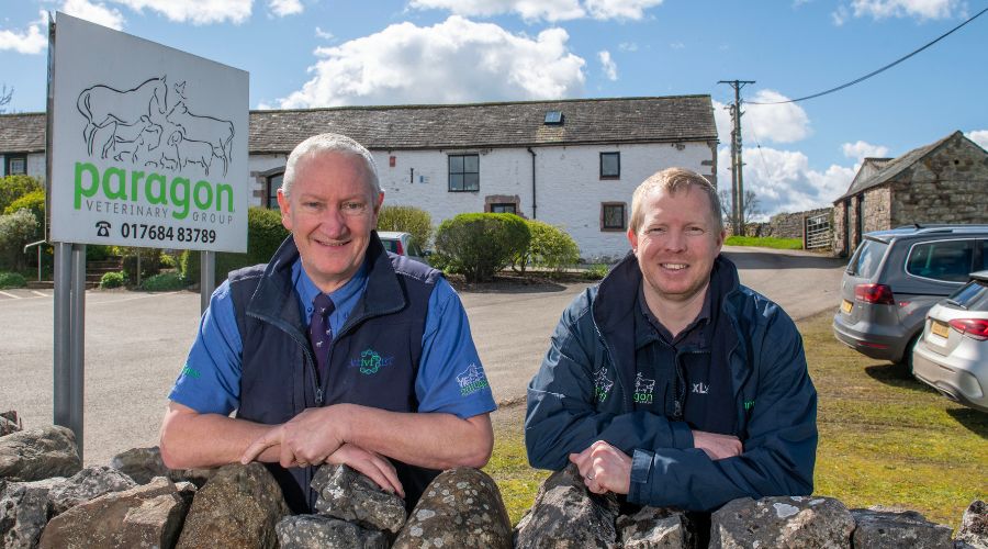 Paragon Veterinary Group senior director David Black, and director and lead vet for advanced breeding, Rob Simmons. Standing outside practice by a stone wall with a Paragon vets sign in the background