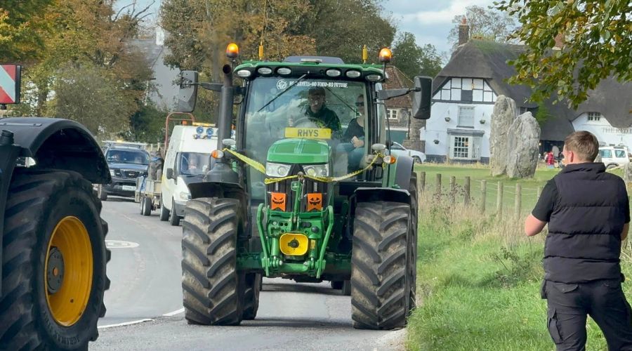 John Deere tractor with halloween pumpkin flags and caution tape on the front 