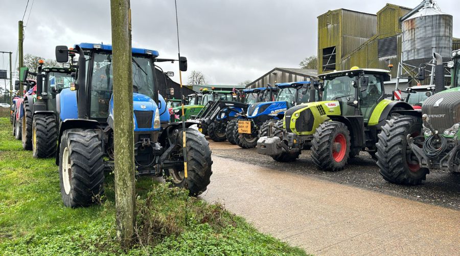 Numerous tractors parked in yard of a farm ready for the protest in Dover