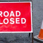 A tractor with a trailer full of straw has overturned on a busy road in Essex. The A120 has been blocked in both directions.