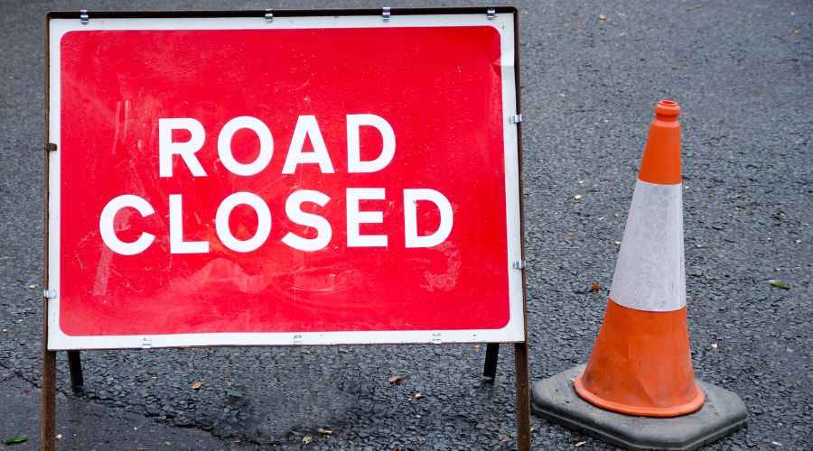 A tractor with a trailer full of straw has overturned on a busy road in Essex. The A120 has been blocked in both directions.