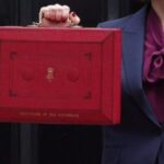 close up of chancellor holding red briefcase for autumn budget