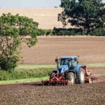 Tractor drilling in field