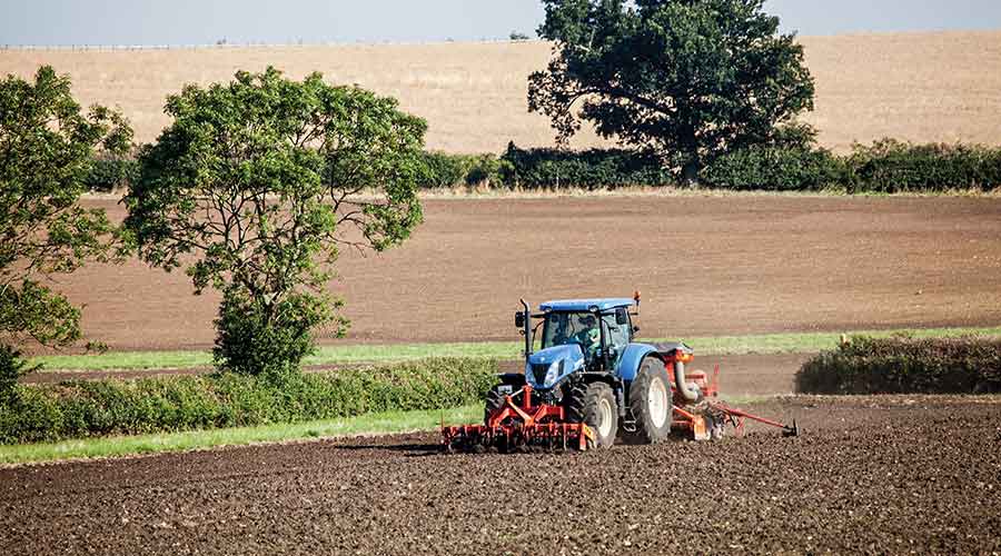 Tractor drilling in field