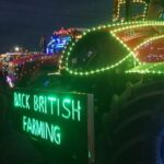 tractor with festive lights and 'Back British farming' written in neon green on the front