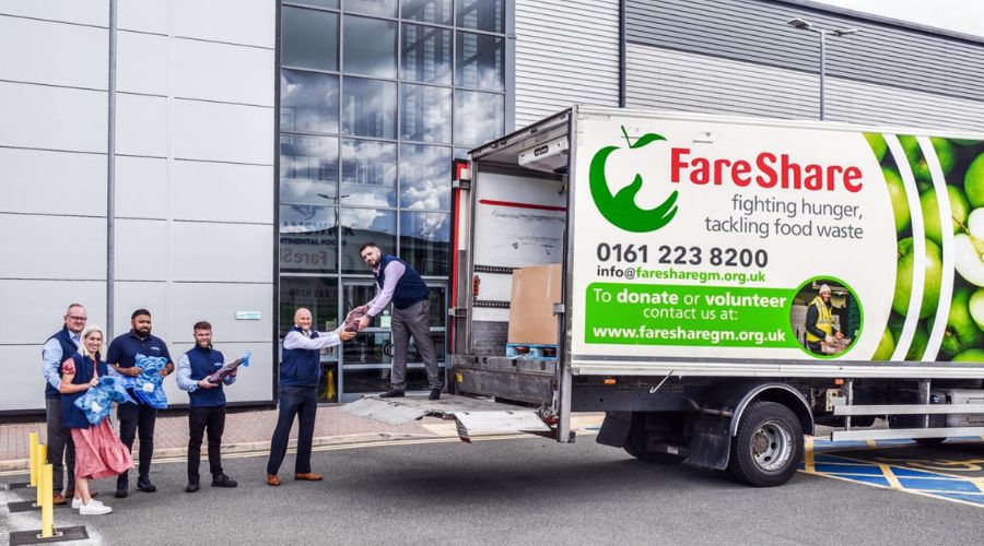 people loading food parcels into a FareShare van