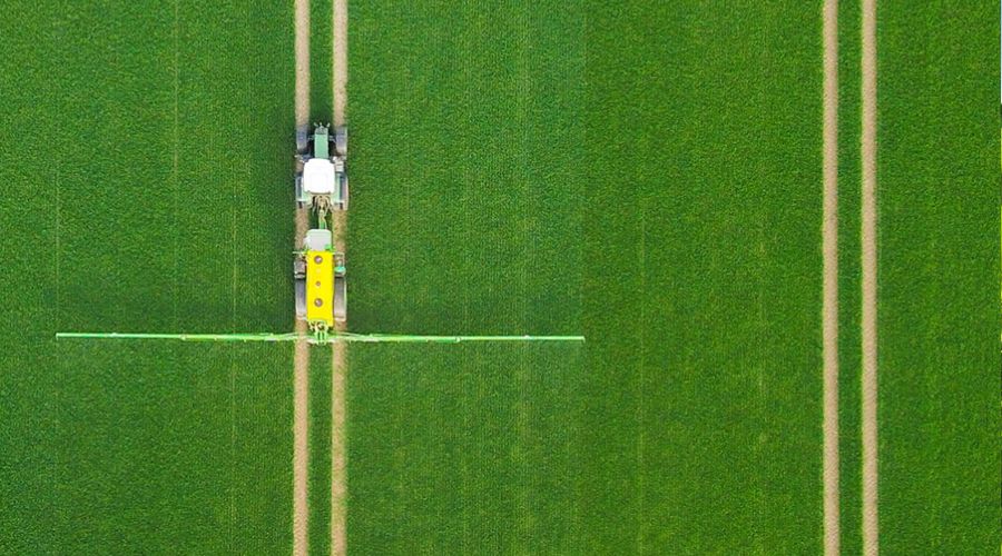 Ascenso tyres on tractor pulling trailed sprayer in farmer's field 