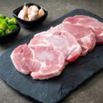 pork chops on a chopping board