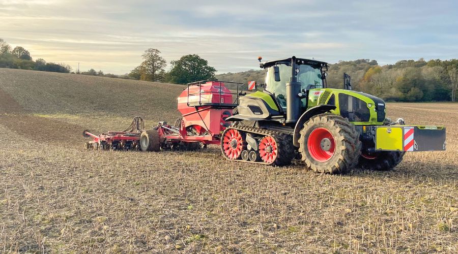 Claas tractor pulling Sumo drill across field